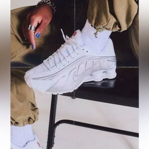 Nike Shox R4 women’s sneakers in white and silver. MSRP $155.00